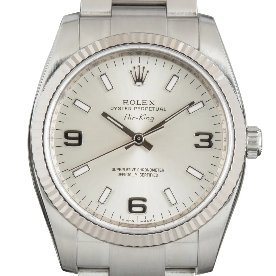 Rolex Air-King 114234 with a silver dial with 3, 6 and 9 numerals and fluted white gold bezel on a steel Oyster bracelet, a pre-owned example, studio close-up of the case