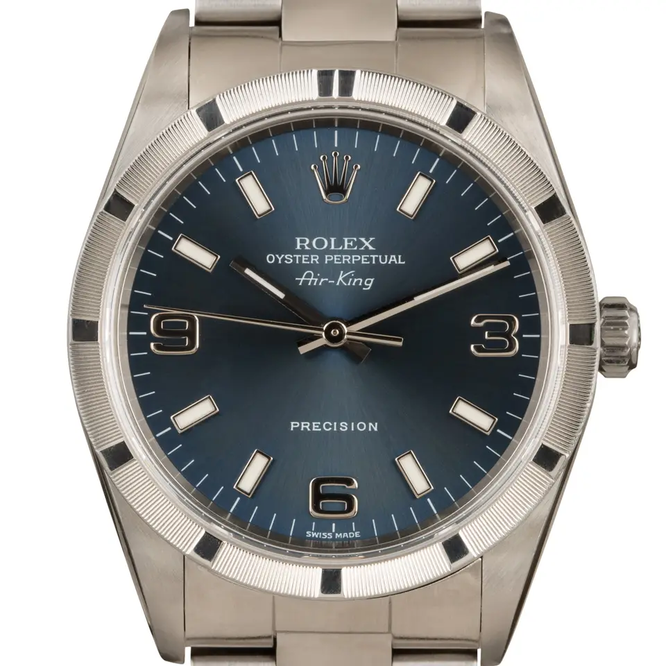 Rolex Air-King 14010M with a blue dial with 3, 6 and 9 numerals and engine-turned steel bezel on an Oyster bracelet, a pre-owned example, studio close-up of the case