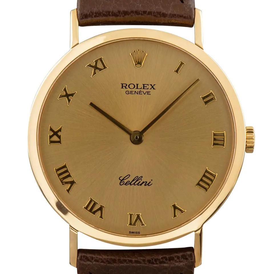 Rolex Cellini 4112 with a champagne Roman-numeral dial, round yellow gold case on a brown leather strap, a pre-owned example, studio close-up of the case