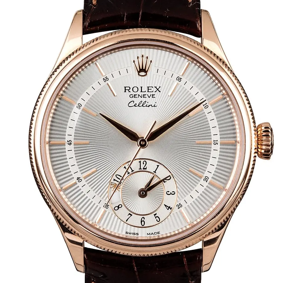 Rolex Cellini Dual Time 50525 with a silver guilloché dial with second time zone sub-dial and fluted Everose bezel on a brown leather strap, a pre-owned example, studio close-up of the case