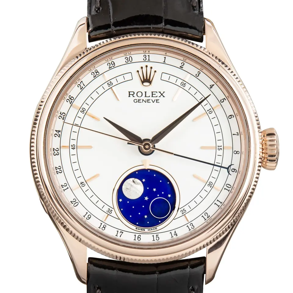 Rolex Cellini Moonphase 50535 with a white dial with moonphase and pointer date and fluted Everose bezel on a black leather strap, a pre-owned example, studio close-up of the case
