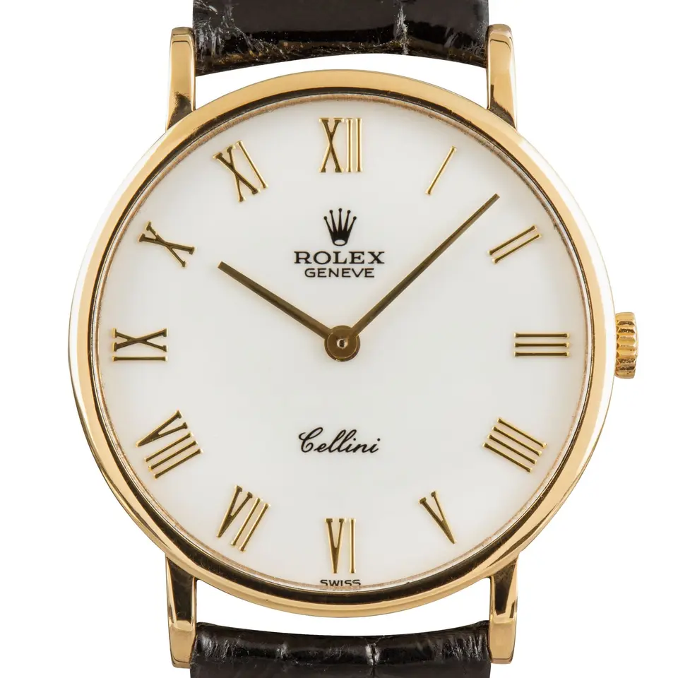 Rolex Cellini 5112 with a white Roman-numeral dial, round yellow gold case on a black leather strap, a pre-owned example, studio close-up of the case