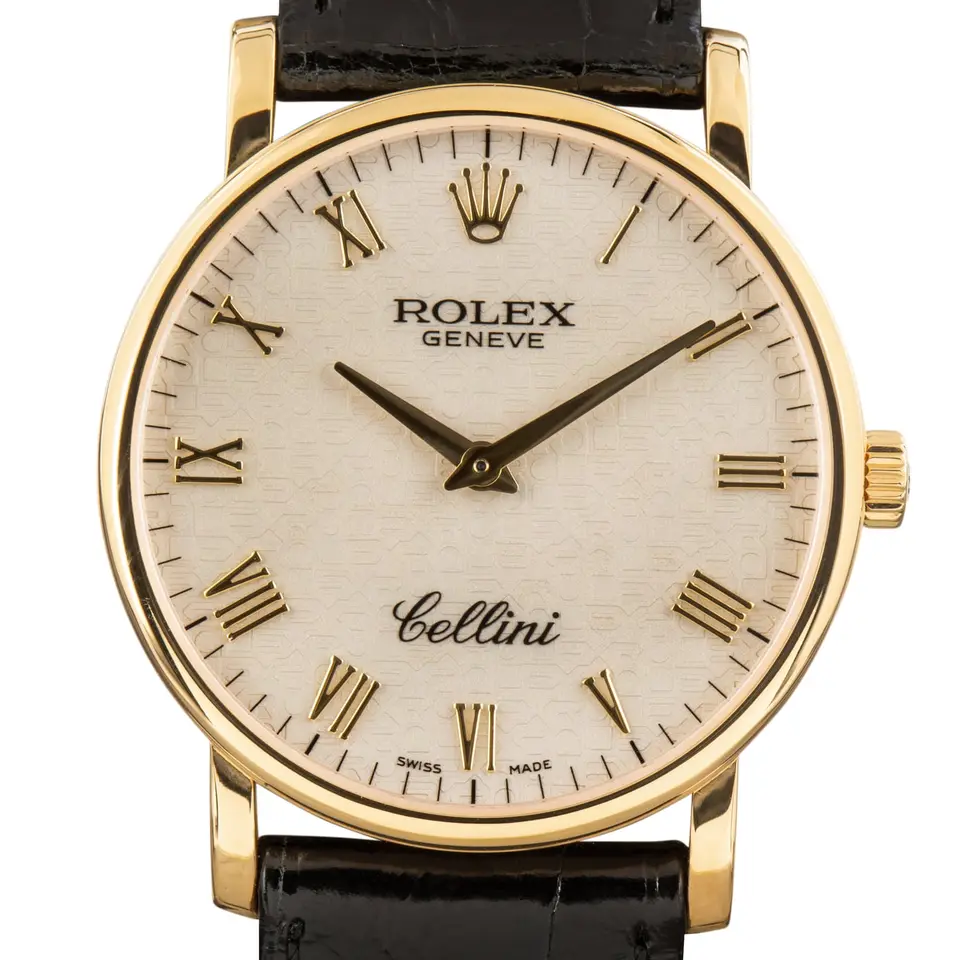 Rolex Cellini 5115 with a silver Roman-numeral dial, round yellow gold case on a black leather strap, a pre-owned example, studio close-up of the case