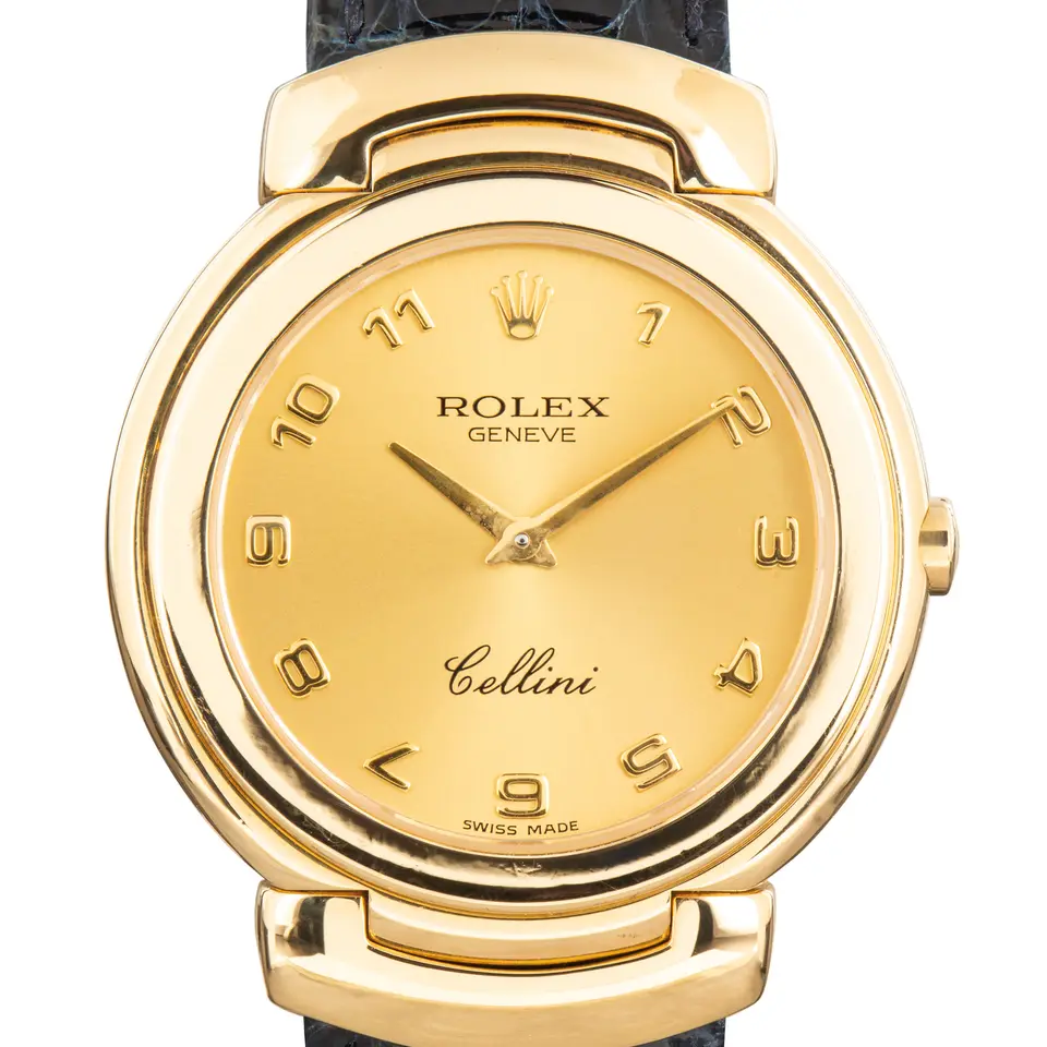 Rolex Cellini 6622 with a champagne Arabic-numeral dial, yellow gold Cellinium case on a navy leather strap, a pre-owned example, studio close-up of the case