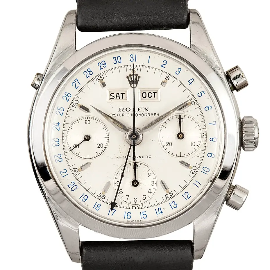 Rolex Chronograph 6036 with a white triple-calendar chronograph dial with day and month windows, steel case on a black leather strap, a pre-owned example, studio close-up of the case