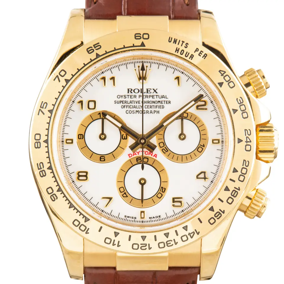Rolex Cosmograph Daytona 116518 with a white dial with Arabic numerals and gold tachymeter bezel in yellow gold on a brown leather strap, a pre-owned example, studio close-up of the case