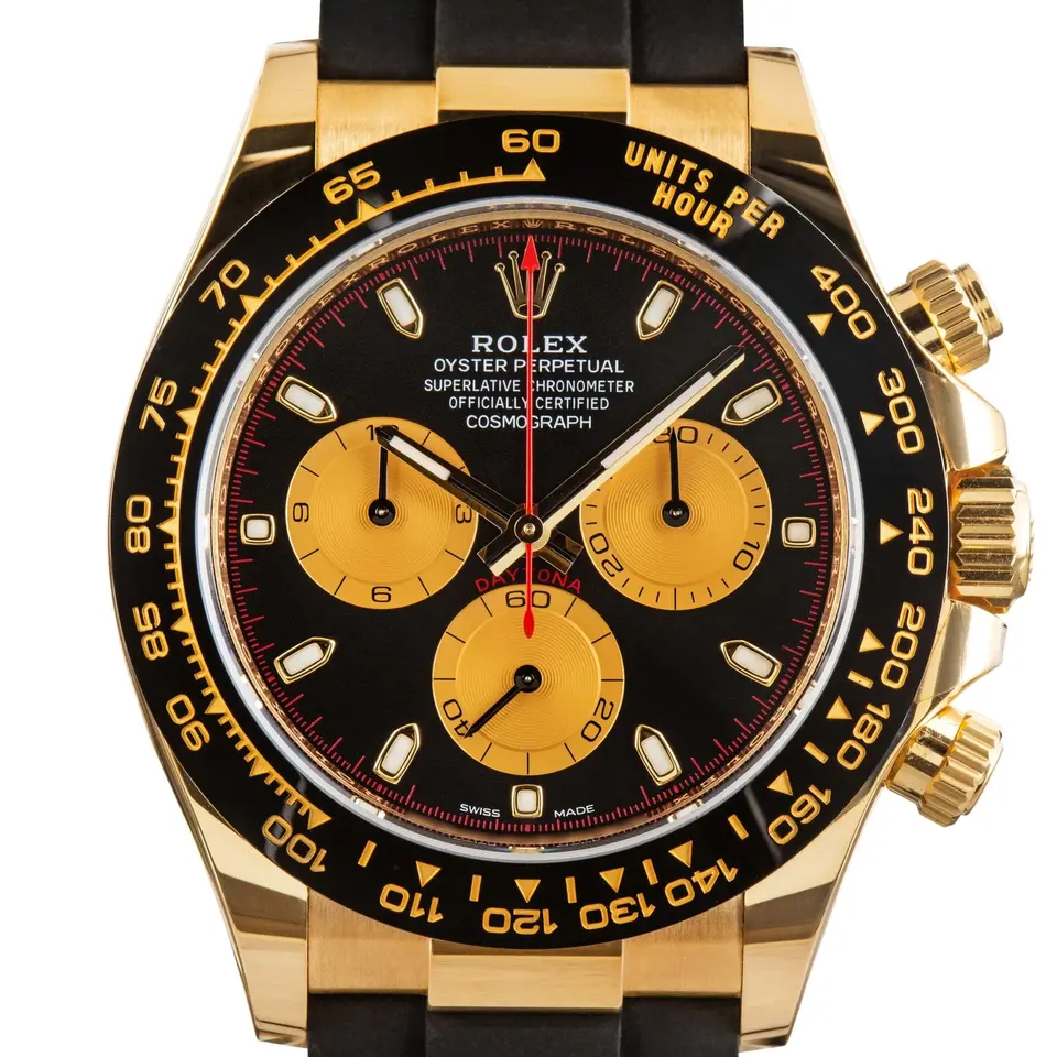 Rolex Cosmograph Daytona 116518LN with a black dial with golden counters and a black ceramic tachymeter bezel in yellow gold on a black Oysterflex strap, a pre-owned example, studio close-up of the case