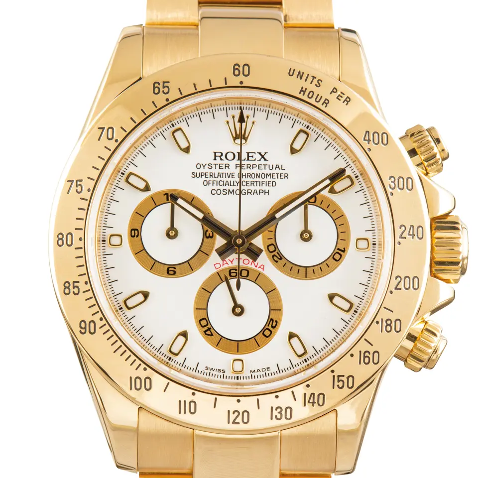 Rolex Cosmograph Daytona 116528 with a white dial with gold-ringed sub-dials in yellow gold on an Oyster bracelet, a pre-owned example, studio close-up of the case