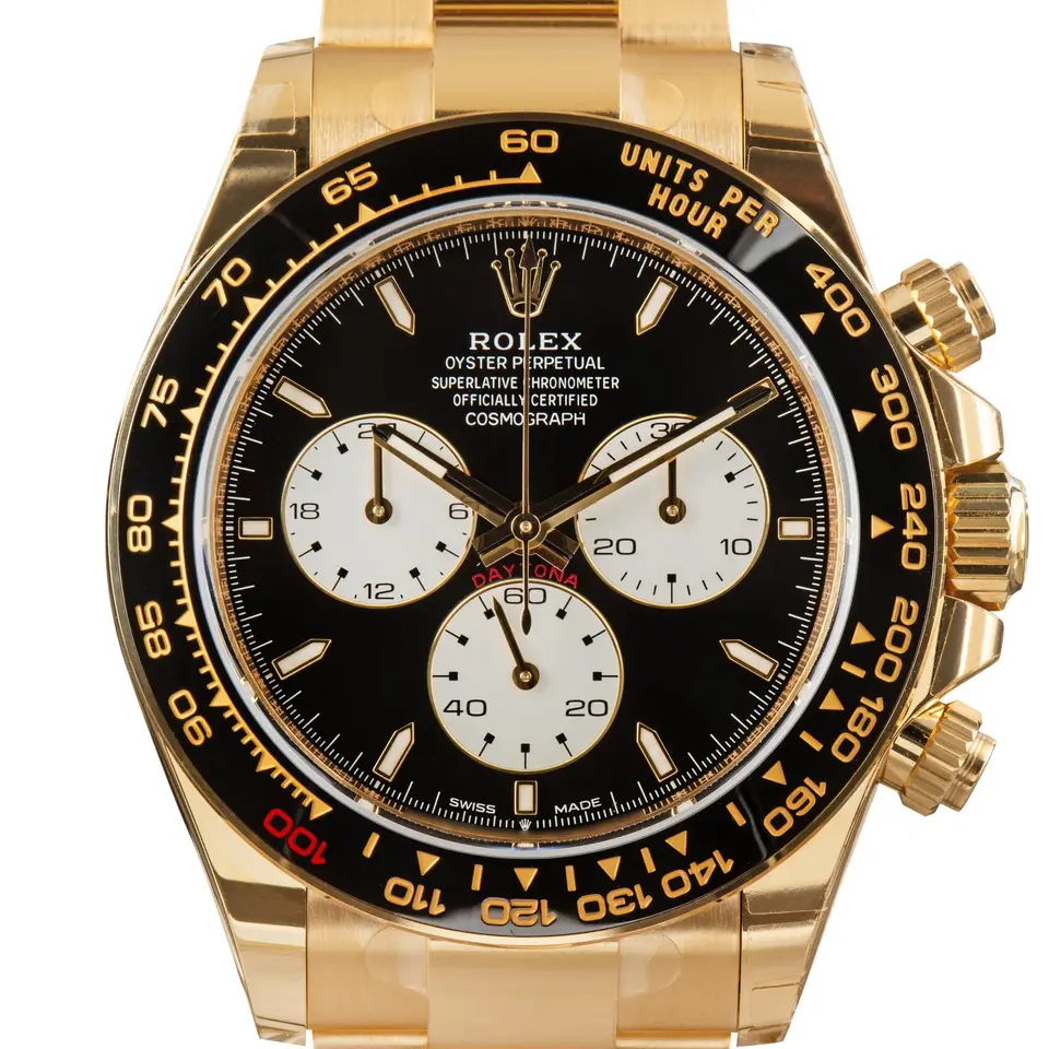 Rolex Cosmograph Daytona 126528LN with a black dial with white sub-dials and black ceramic bezel in yellow gold on an Oyster bracelet, a pre-owned example, studio close-up of the case
