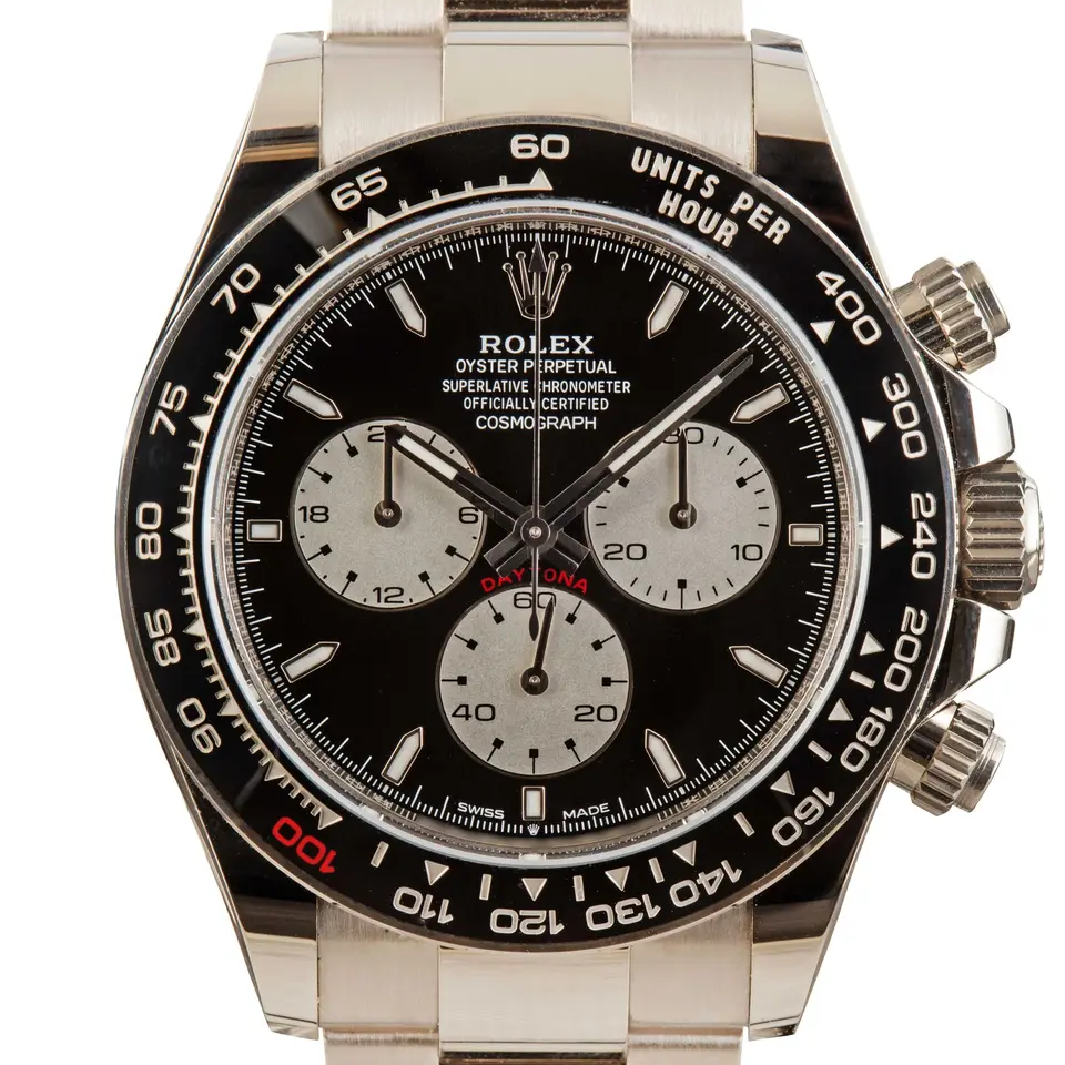 Rolex Cosmograph Daytona 126529LN with a black dial with white counters and a black ceramic bezel with a red 100 (Le Mans) in white gold on a metal bracelet, a pre-owned example, studio close-up of the case