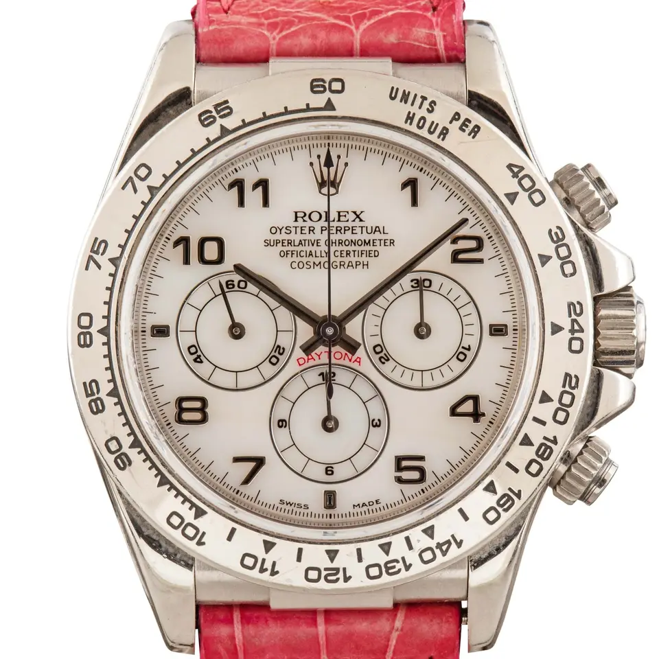 Rolex Cosmograph Daytona 16519 with a white dial with Arabic numerals in white gold on a leather strap, a pre-owned example, studio close-up of the case