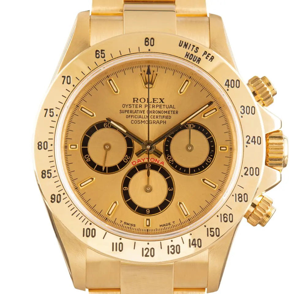 Rolex Cosmograph Daytona 16528 with a champagne dial with black-ringed sub-dials in yellow gold on an Oyster bracelet, a pre-owned example, studio close-up of the case