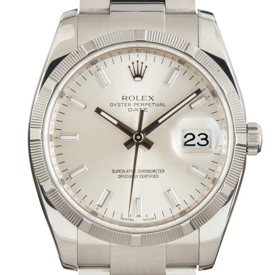 Rolex Oyster Perpetual Date 34 115210 with a silver dial with date, engine-turned steel bezel and steel Oyster bracelet, a pre-owned example, studio close-up of the case