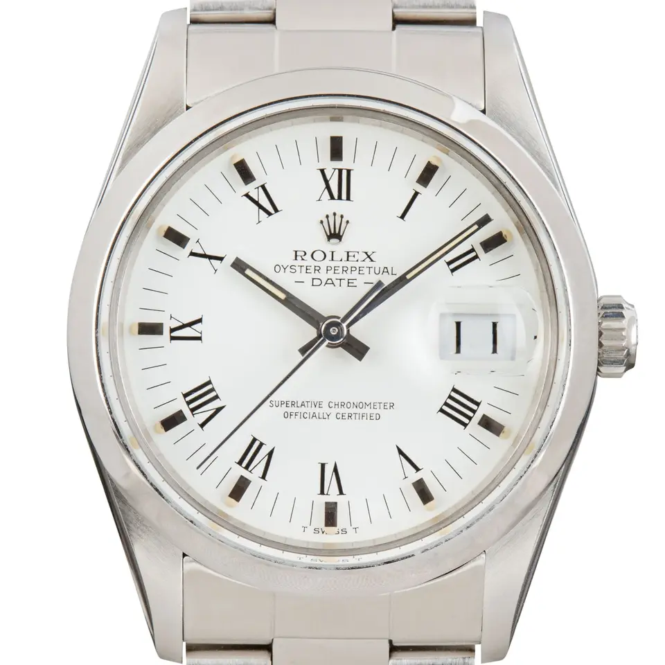 Rolex Date 15000 with a white Roman-numeral dial, engine-turned steel bezel and steel Oyster bracelet, a pre-owned example, studio close-up of the case