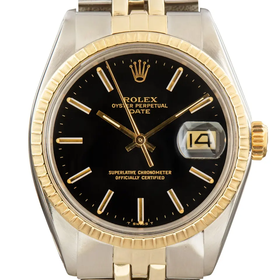Rolex Date 1505 with a black dial, engine-turned yellow gold bezel and steel and gold Jubilee bracelet, a pre-owned example, studio close-up of the case