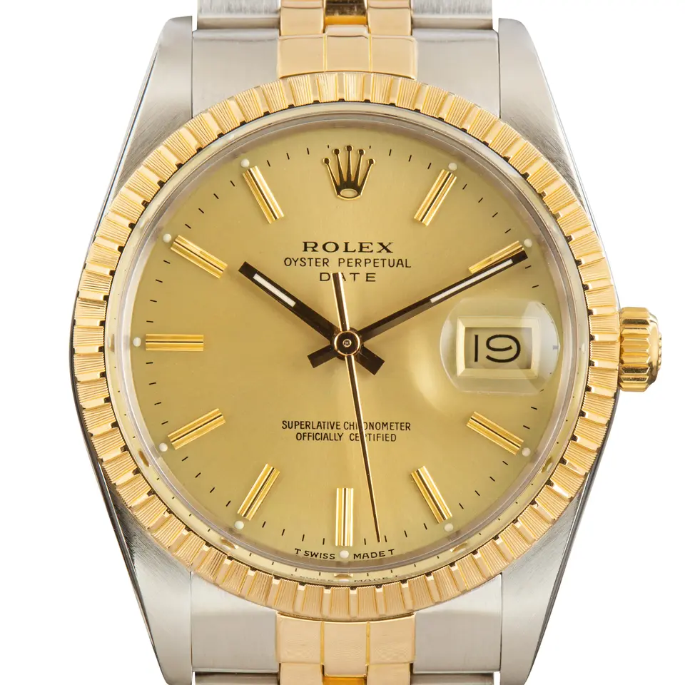 Rolex Oyster Perpetual Date 15053 with a champagne dial, engine-turned yellow gold bezel and steel and gold Jubilee bracelet, a pre-owned example, studio close-up of the case