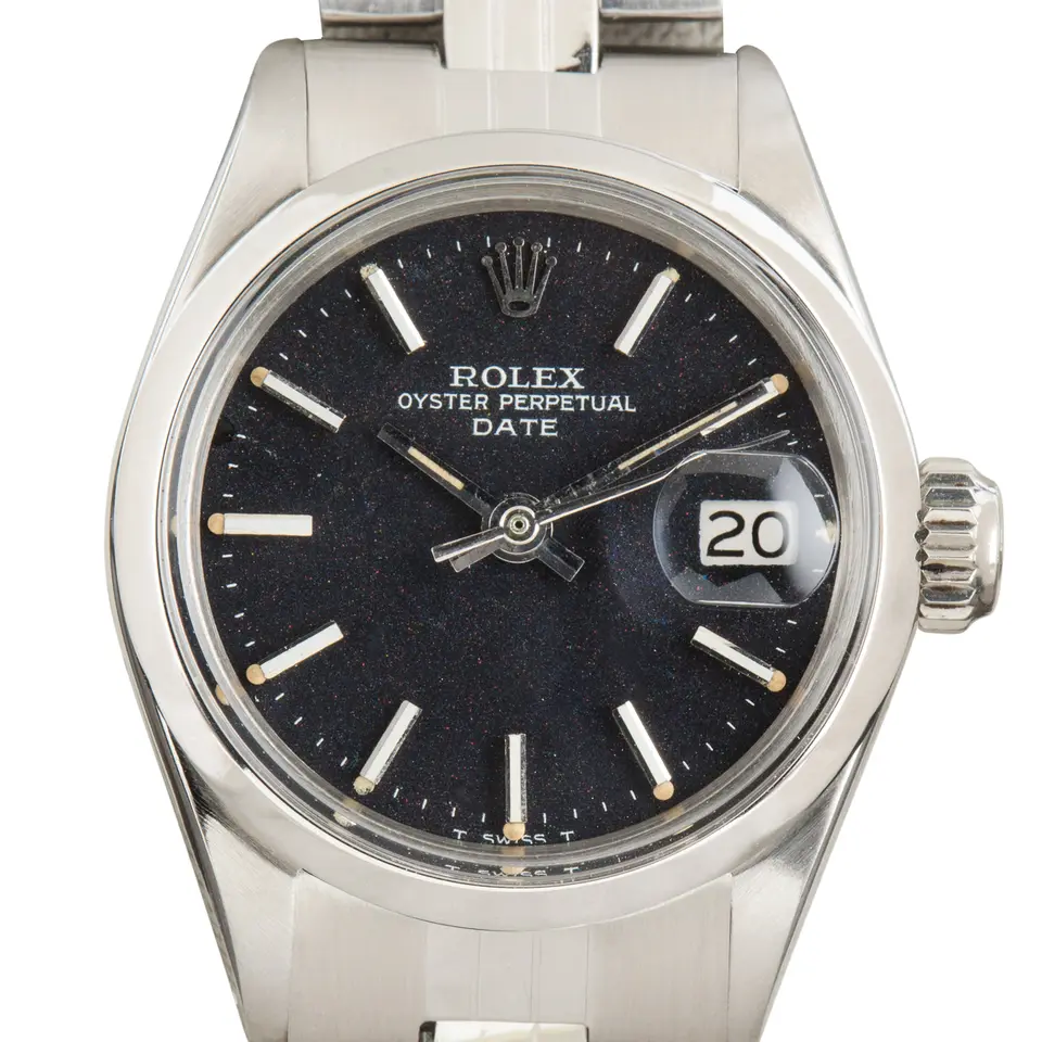 Rolex Oyster Perpetual Lady Date 26 6516 with a black dial, smooth steel bezel and steel Oyster bracelet, a pre-owned example, studio close-up of the case