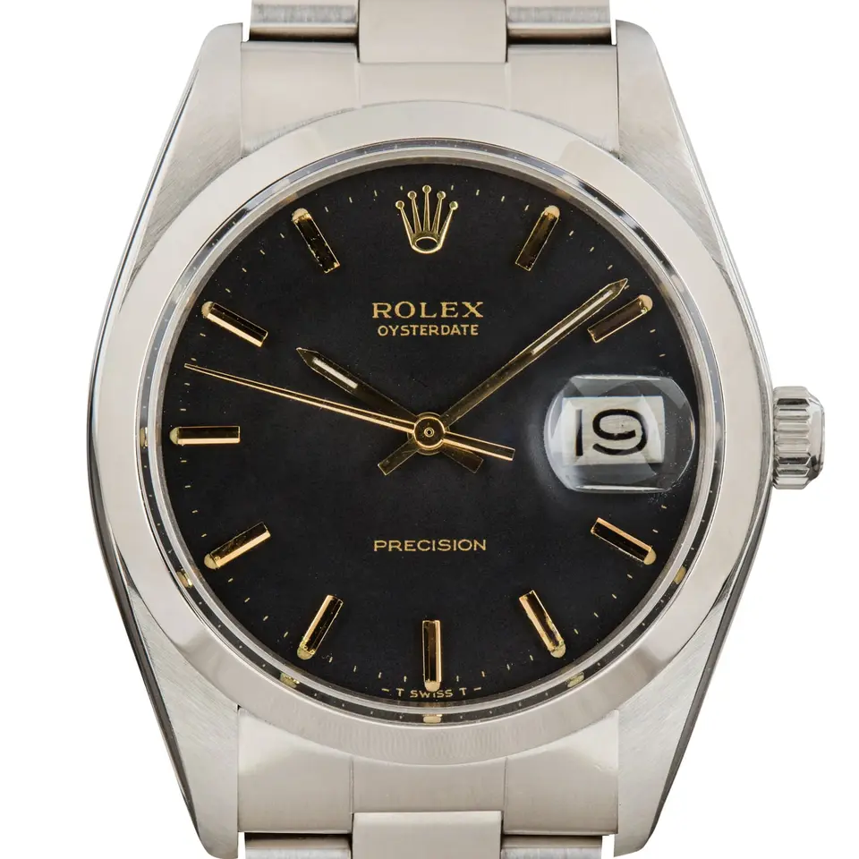 Rolex Oysterdate Precision 6694 with a black OysterDate Precision dial, smooth steel bezel and steel Oyster bracelet, a pre-owned example, studio close-up of the case