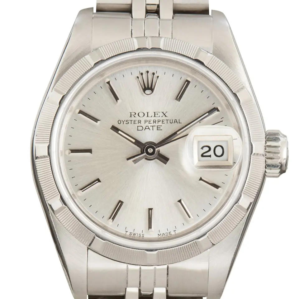Rolex Oyster Perpetual Lady Date 26 69190 with a silver dial, engine-turned steel bezel and steel Oyster bracelet, a pre-owned example, studio close-up of the case