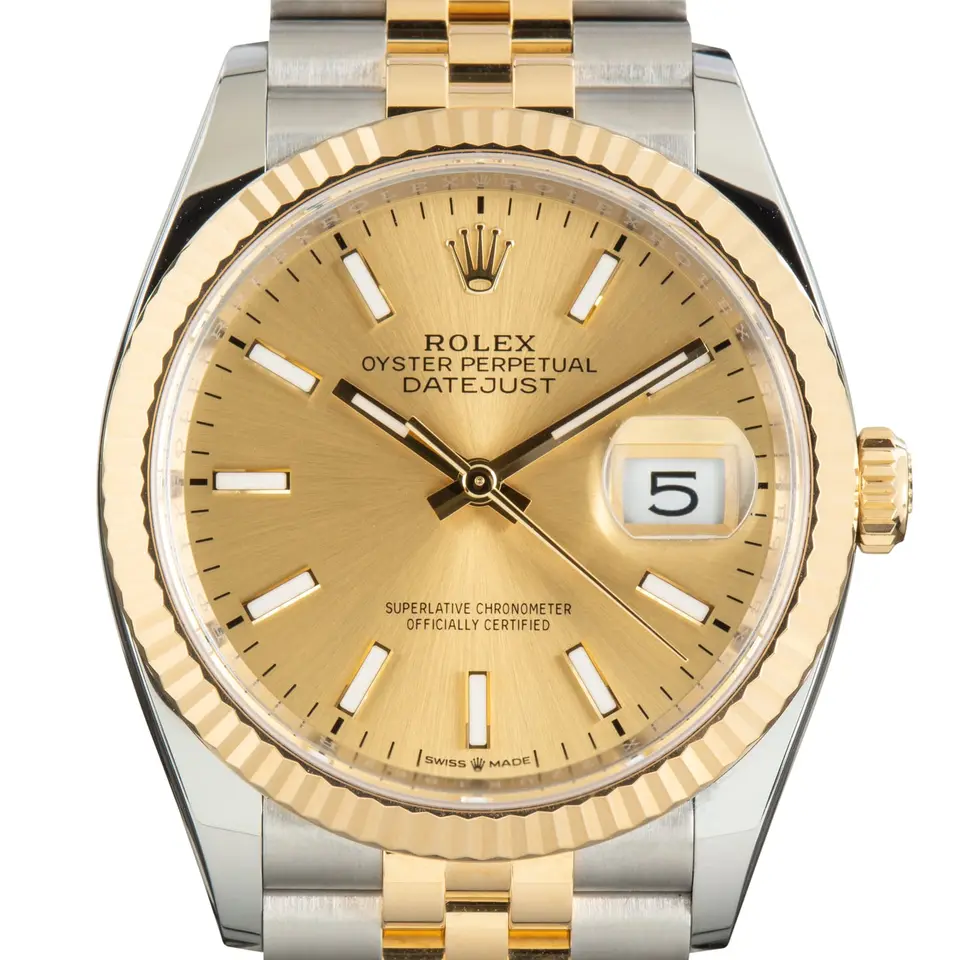 Rolex Datejust 36 126233 with a golden dial and a fluted yellow gold bezel, a pre-owned example, studio close-up of the case