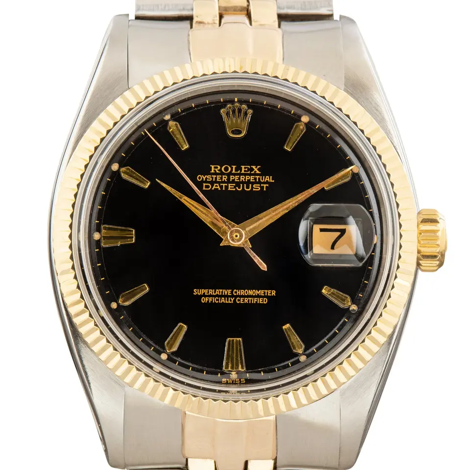 Rolex Datejust 1601 with a black pie-pan dial and fluted yellow gold bezel on a Jubilee bracelet, a pre-owned example, studio close-up of the case