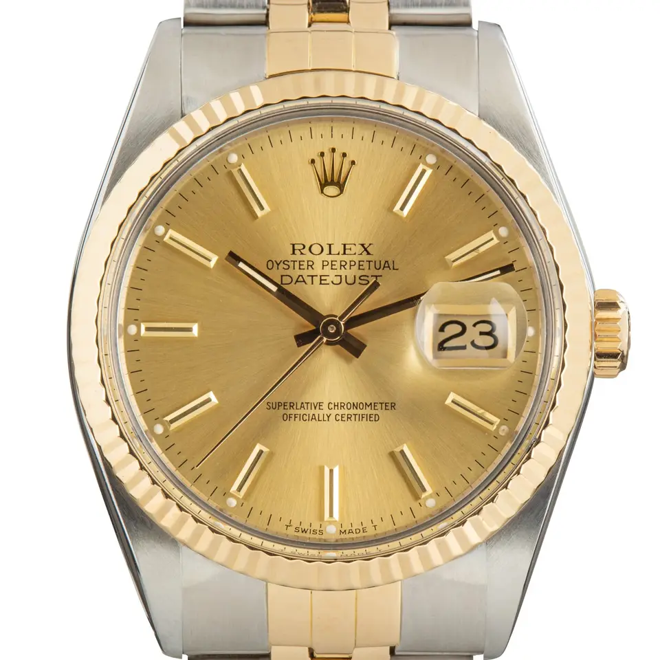 Rolex Datejust 16013 with a champagne dial with baton markers and date and a fluted yellow gold bezel on a two-tone Jubilee bracelet, a pre-owned example, studio close-up of the case