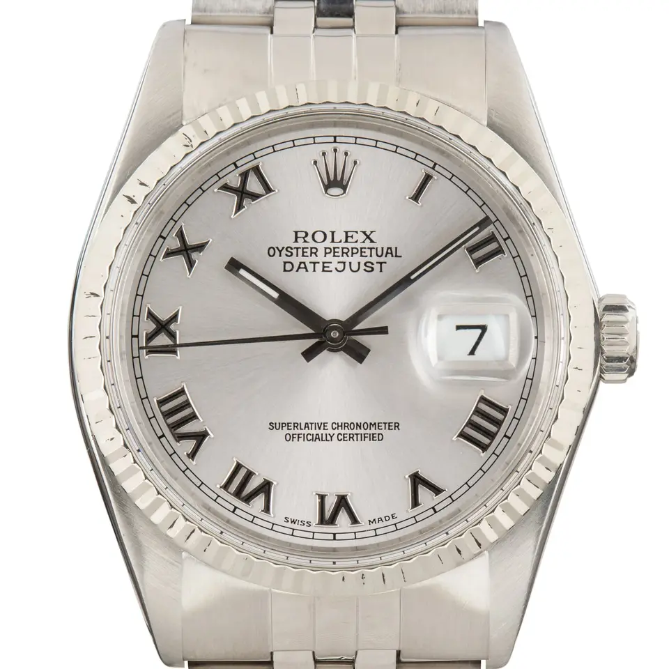 Rolex Datejust 16014 with a silver dial with Roman numerals and fluted white gold bezel on a Jubilee bracelet, a pre-owned example, studio close-up of the case