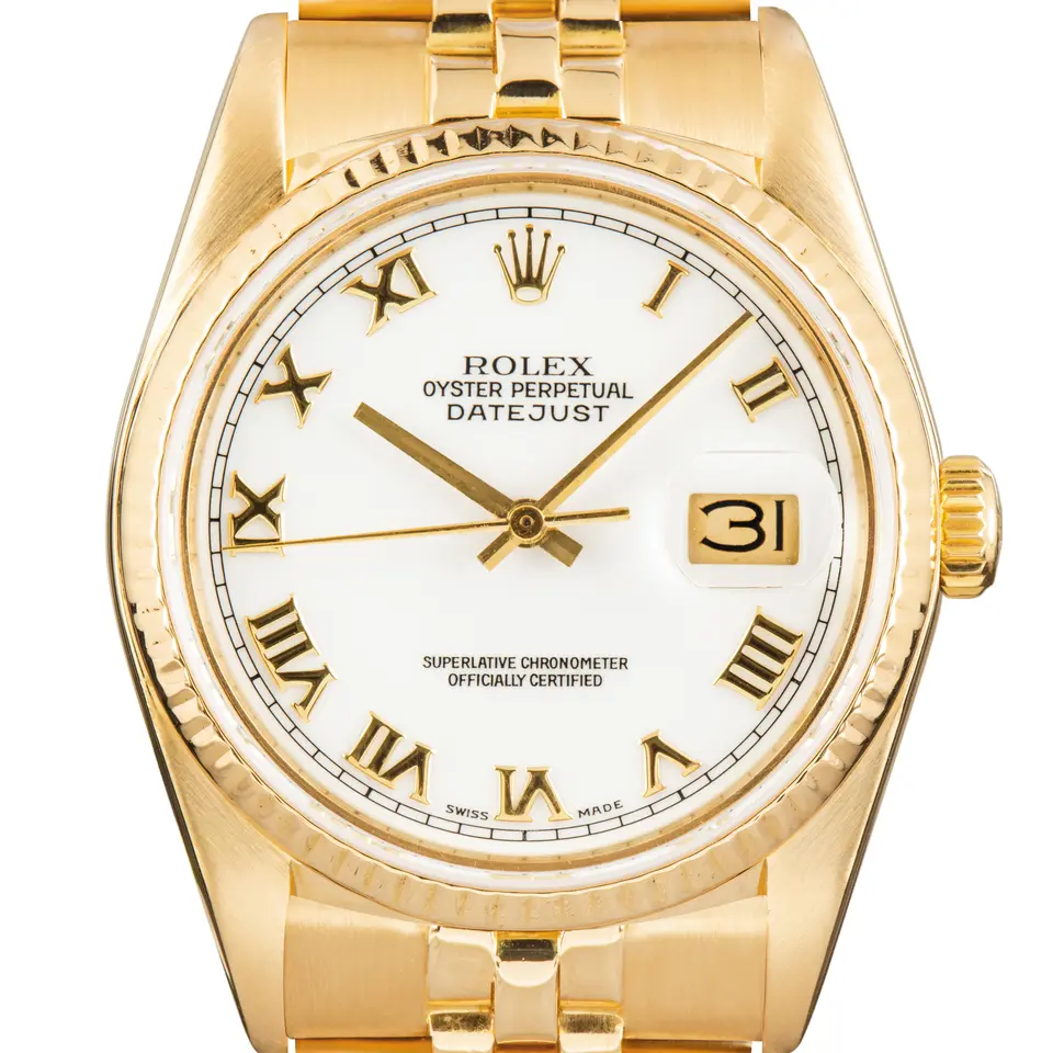Rolex Datejust 16018 with a white dial with Roman numerals and fluted bezel in yellow gold on a Jubilee bracelet, a pre-owned example, studio close-up of the case