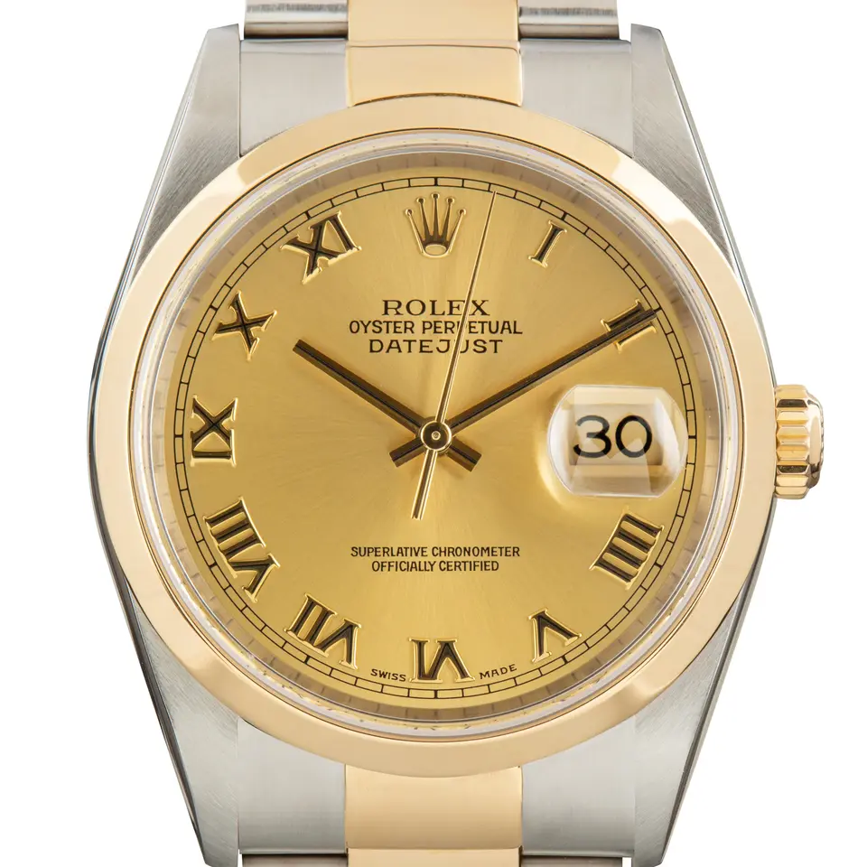 Rolex Datejust 16203 with a champagne dial with Roman numerals and smooth yellow gold bezel in steel and yellow gold on an Oyster bracelet, a pre-owned example, studio close-up of the case