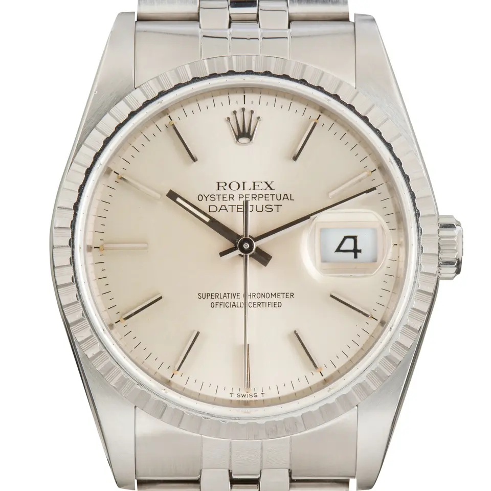 Rolex Datejust 16220 with a silver dial and engine-turned steel bezel on a Jubilee bracelet, a pre-owned example, studio close-up of the case