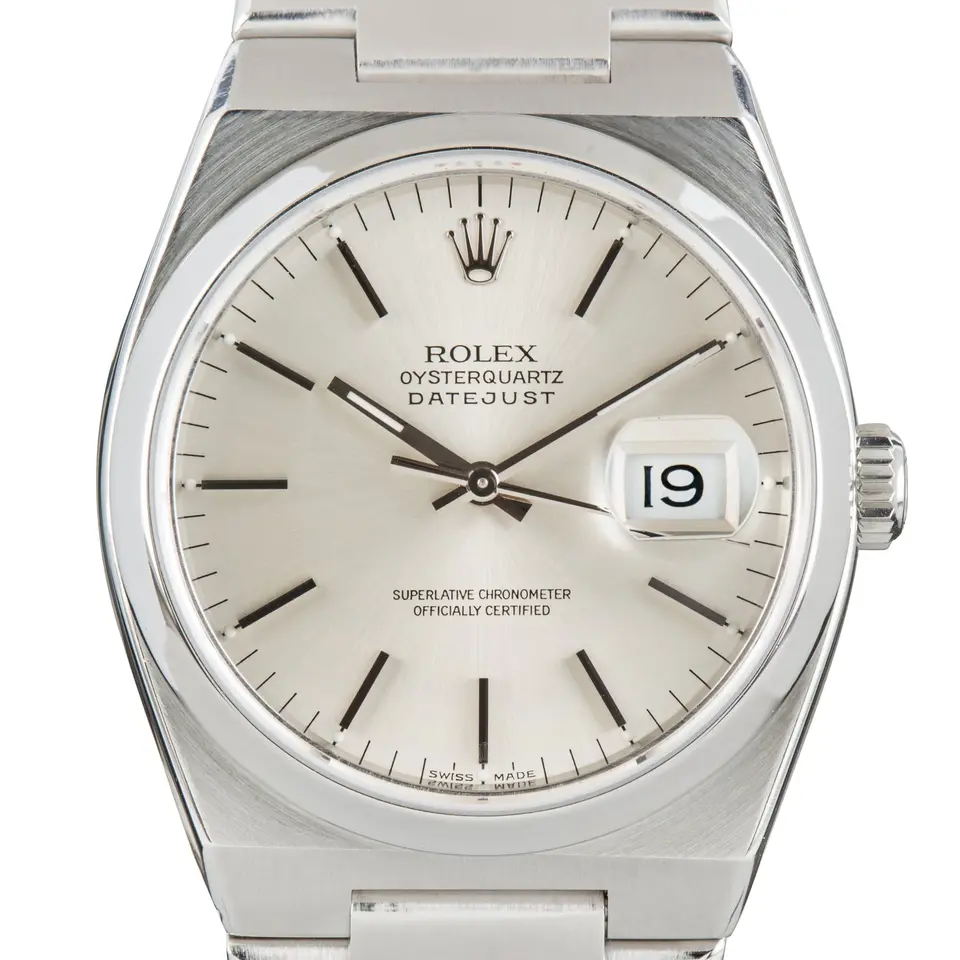 Rolex Oysterquartz Datejust 17000 with a silver dial and steel case on an integrated Oysterquartz bracelet, a pre-owned example, studio close-up of the case