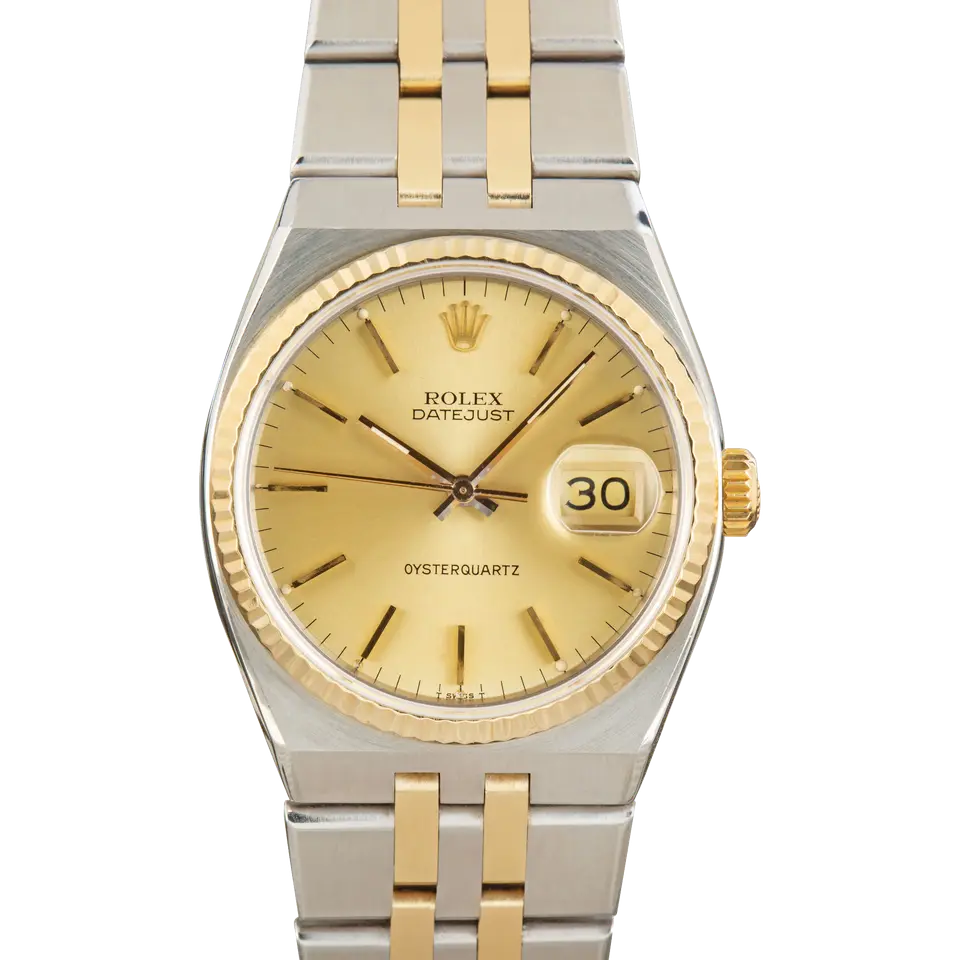 Rolex Oysterquartz Datejust 17013 with a champagne dial and fluted yellow gold bezel in steel and yellow gold on an integrated Oysterquartz bracelet, a pre-owned example, front view of the whole watch