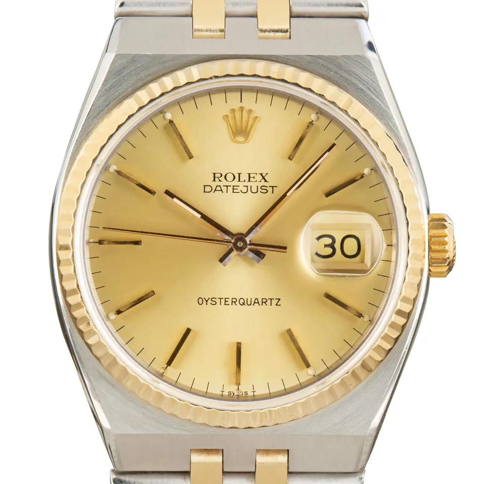 Rolex Oysterquartz Datejust 17013 with a champagne dial and fluted yellow gold bezel in steel and yellow gold on an integrated Oysterquartz bracelet, a pre-owned example, studio close-up of the case