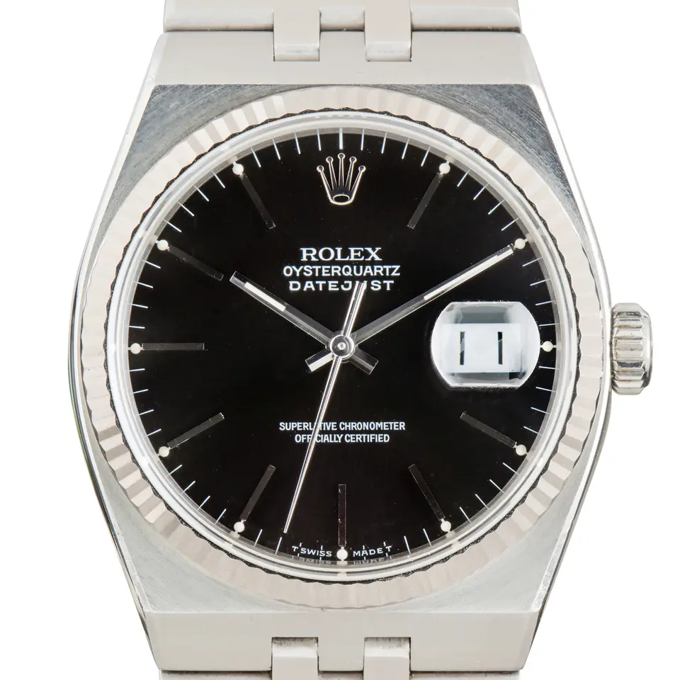 Rolex Oysterquartz Datejust 17014 with a black Oysterquartz dial, fluted white gold bezel and integrated steel bracelet, a pre-owned example, studio close-up of the case
