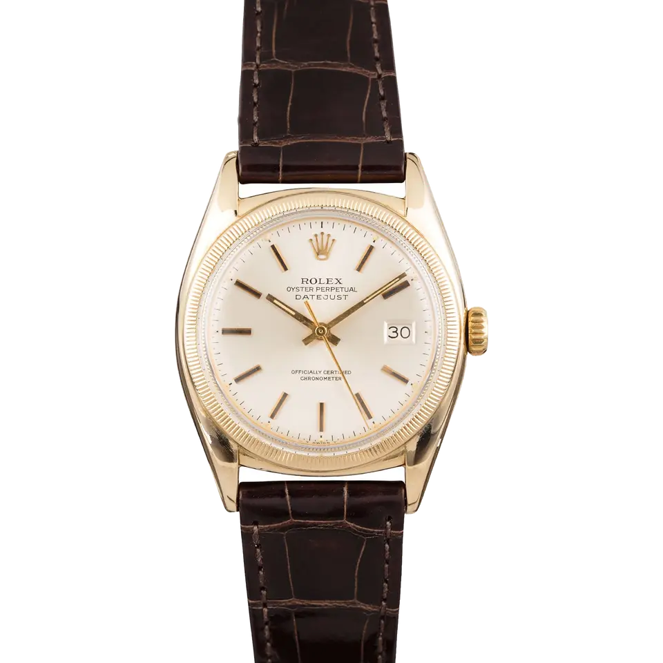 Rolex Datejust 6105 with a silver dial, engine-turned gold bezel and gold case on a brown leather strap, a pre-owned example, front view of the whole watch