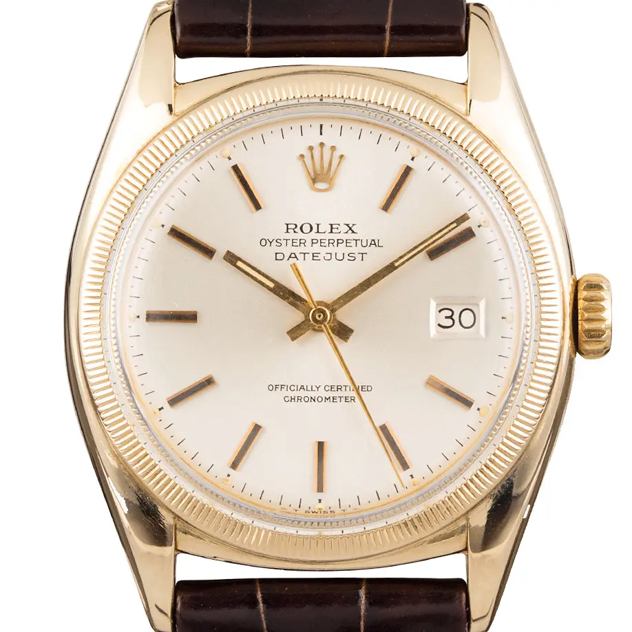 Rolex Datejust 6105 with a silver dial, engine-turned gold bezel and gold case on a brown leather strap, a pre-owned example, studio close-up of the case