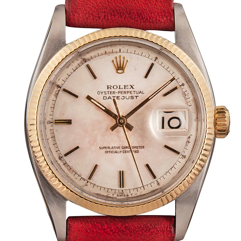 Rolex Datejust 6605 with a rose-tinted dial, fluted gold bezel and steel and gold case on a red leather strap, a pre-owned example, studio close-up of the case