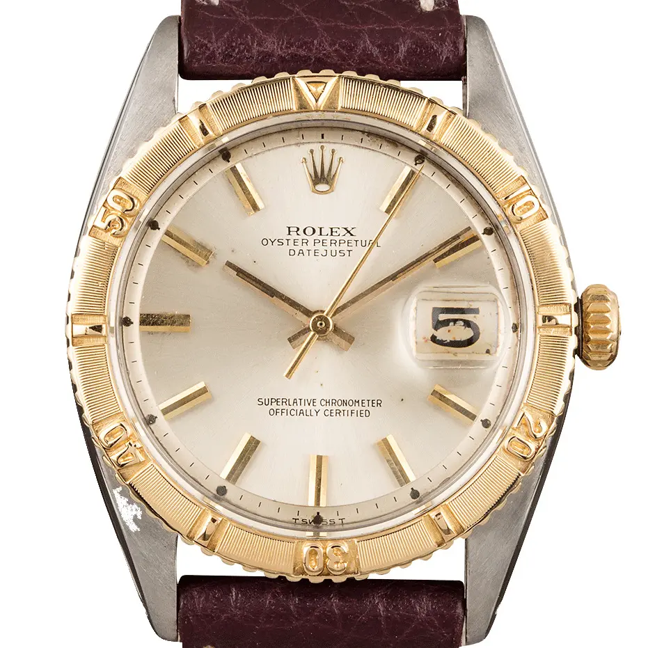 Rolex Datejust Turn-O-Graph 6609 with a silver dial, yellow gold Turn-O-Graph bezel and steel and gold case on a burgundy leather strap, a pre-owned example, studio close-up of the case