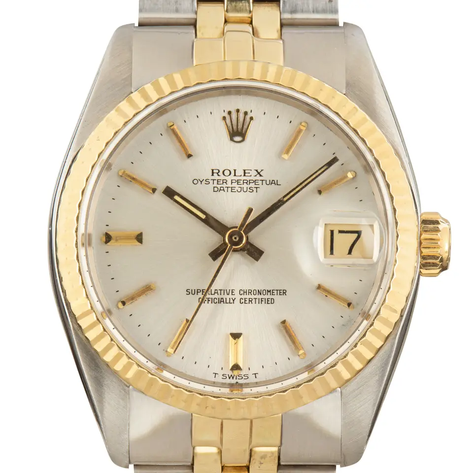 Rolex Datejust 31 6827 with a silver dial and fluted bezel in yellow gold on a Jubilee bracelet, a pre-owned example, studio close-up of the case