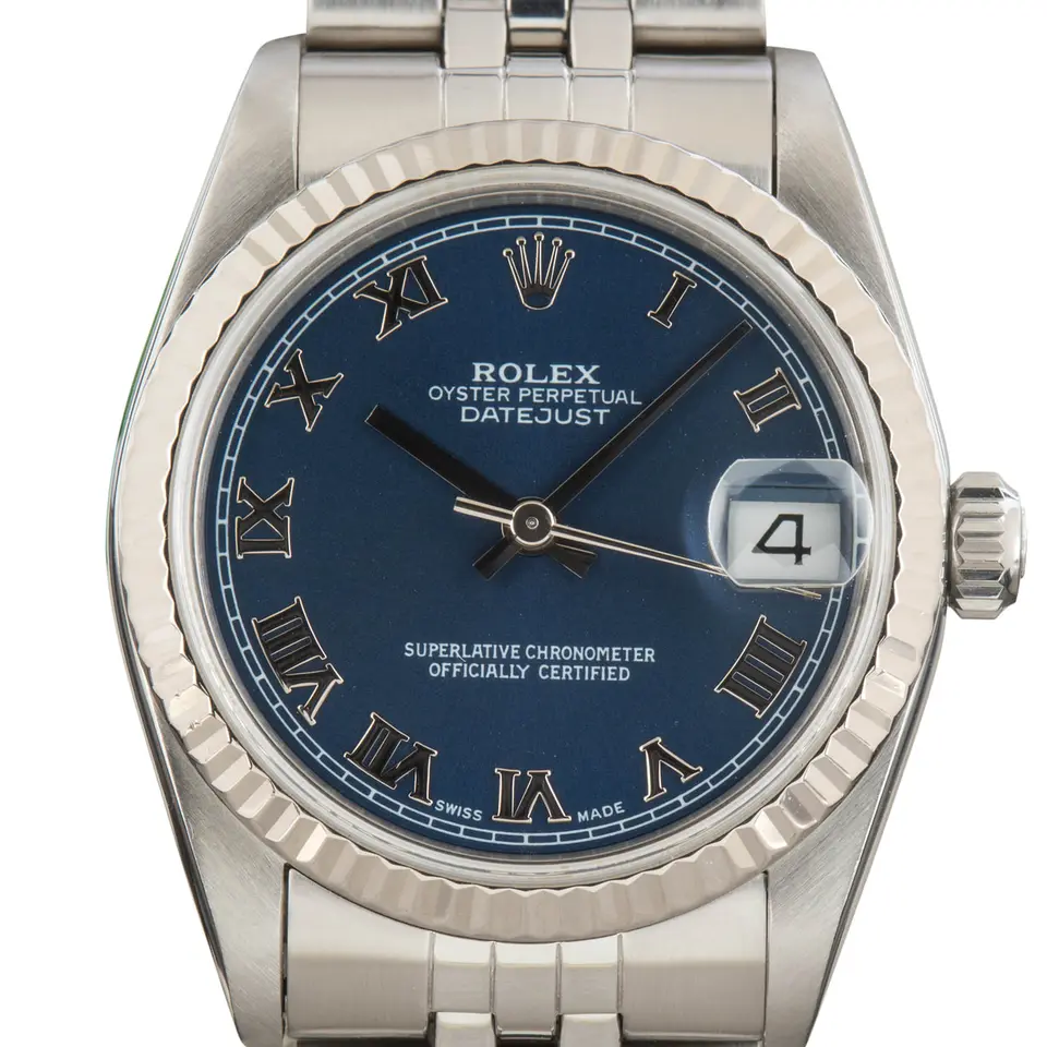 Rolex Datejust 31 68274 with a blue dial with Roman numerals and fluted white gold bezel on a steel Jubilee bracelet, a pre-owned example, studio close-up of the case
