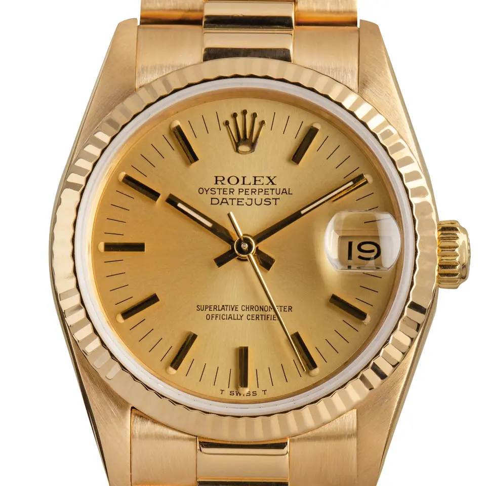 Rolex Datejust 31 68278 with a champagne dial, fluted yellow gold bezel and yellow gold President bracelet, a pre-owned example, studio close-up of the case