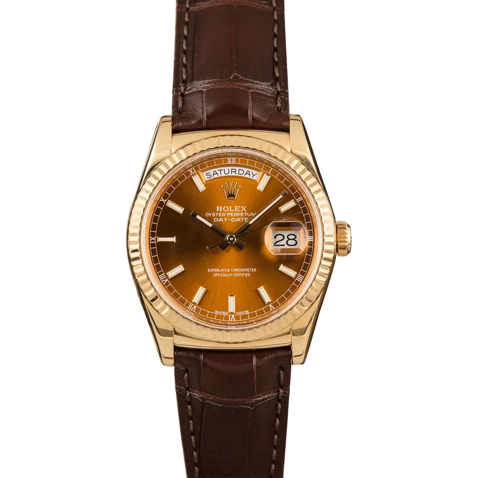 Rolex Day-Date 36 118138 with a cognac dial and fluted bezel in yellow gold on a brown leather strap, a pre-owned example, front view of the whole watch