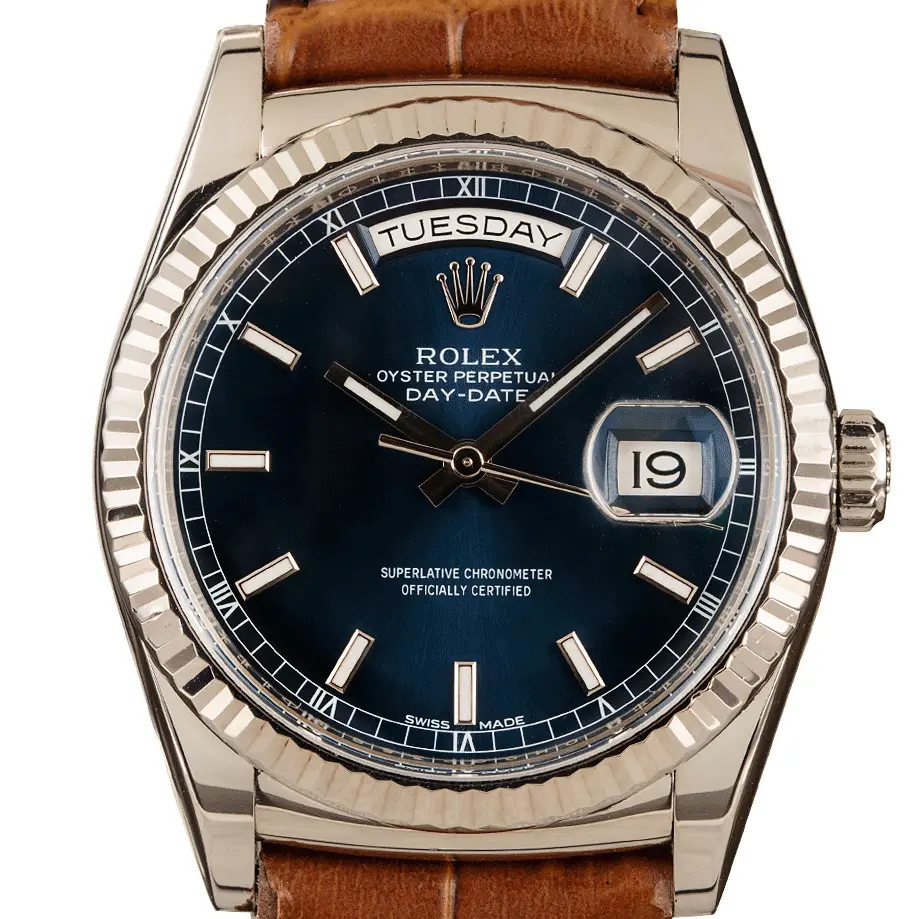Rolex Day-Date 36 118139 with a blue dial and fluted bezel in white gold on a brown leather strap, a pre-owned example, studio close-up of the case