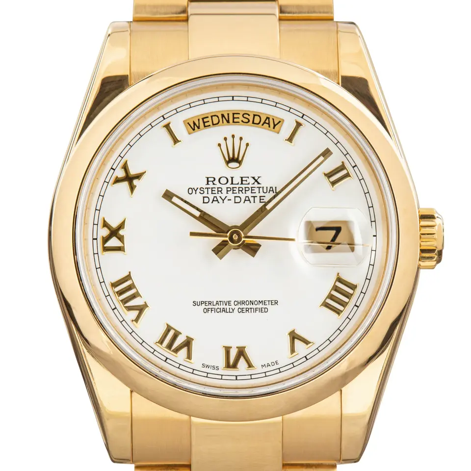 Rolex Day-Date 36 118208 with a white dial with Roman numerals and smooth bezel in yellow gold on an Oyster bracelet, a pre-owned example, studio close-up of the case