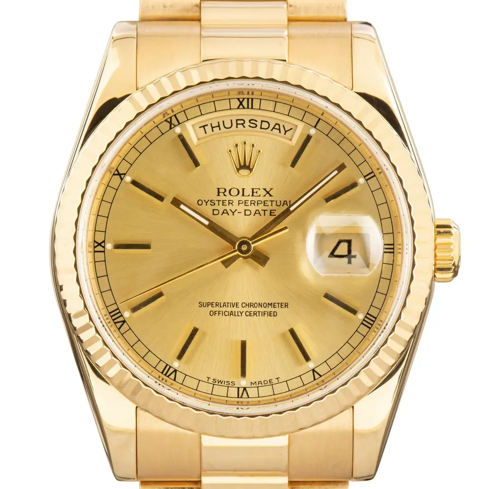 Rolex Day-Date 36 118238 with a champagne dial and fluted bezel in yellow gold on a President bracelet, a pre-owned example, studio close-up of the case