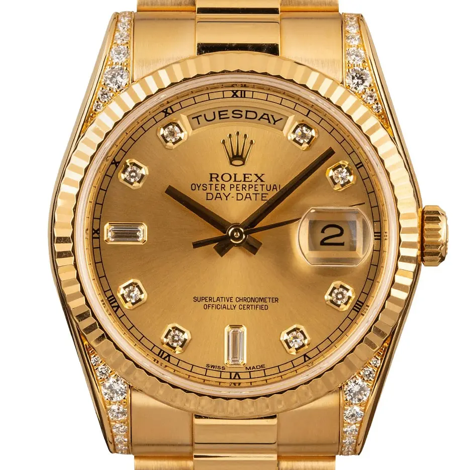 Rolex Day-Date 118338 with a champagne dial with diamond hour markers, fluted yellow gold bezel, diamond-set lugs and yellow gold President bracelet, a pre-owned example, studio close-up of the case