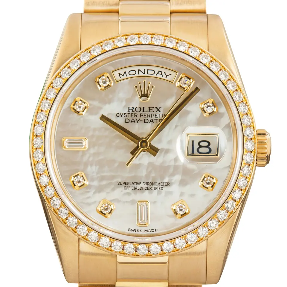 Rolex Day-Date 36 118348 with a mother-of-pearl dial with diamond markers and diamond-set bezel in yellow gold on a President bracelet, a pre-owned example, studio close-up of the case