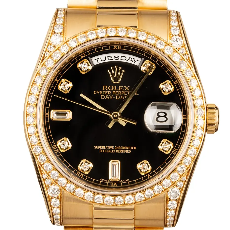 Rolex Day-Date 36 118388 with a black dial with diamond markers, diamond-set bezel and lugs in yellow gold on a President bracelet, a pre-owned example, studio close-up of the case