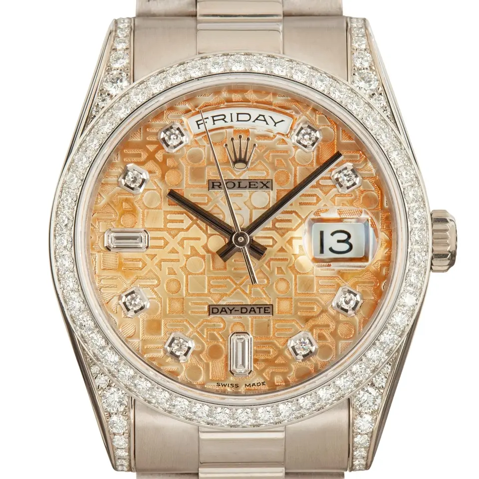 Rolex Day-Date 36 118389 with a salmon Jubilee-pattern dial with diamond markers, diamond-set bezel and lugs in white gold on a President bracelet, a pre-owned example, studio close-up of the case
