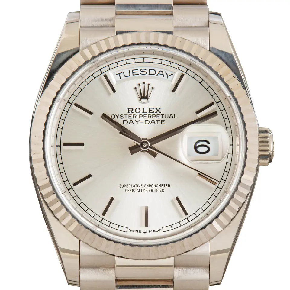 Rolex Day-Date 36 128239 with a silver dial and a fluted white gold bezel, a pre-owned example, studio close-up of the case